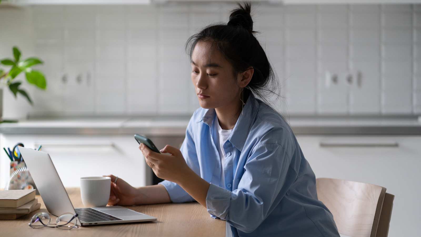 A dejected professional woman looks for work, having been overlooked by AI recruiting software for job applications