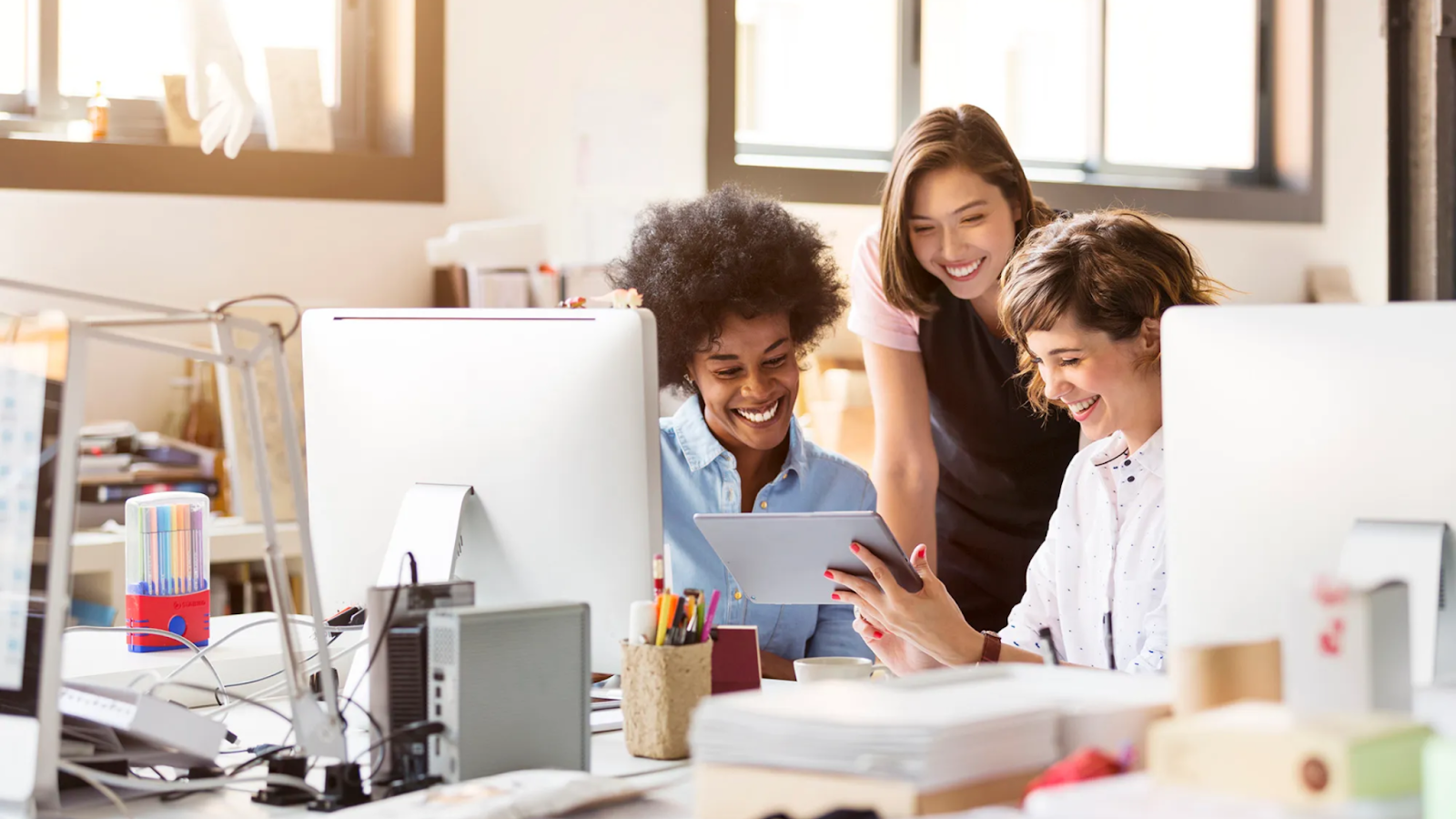 Officer workers are engaged at work while happily working with their fellow team members