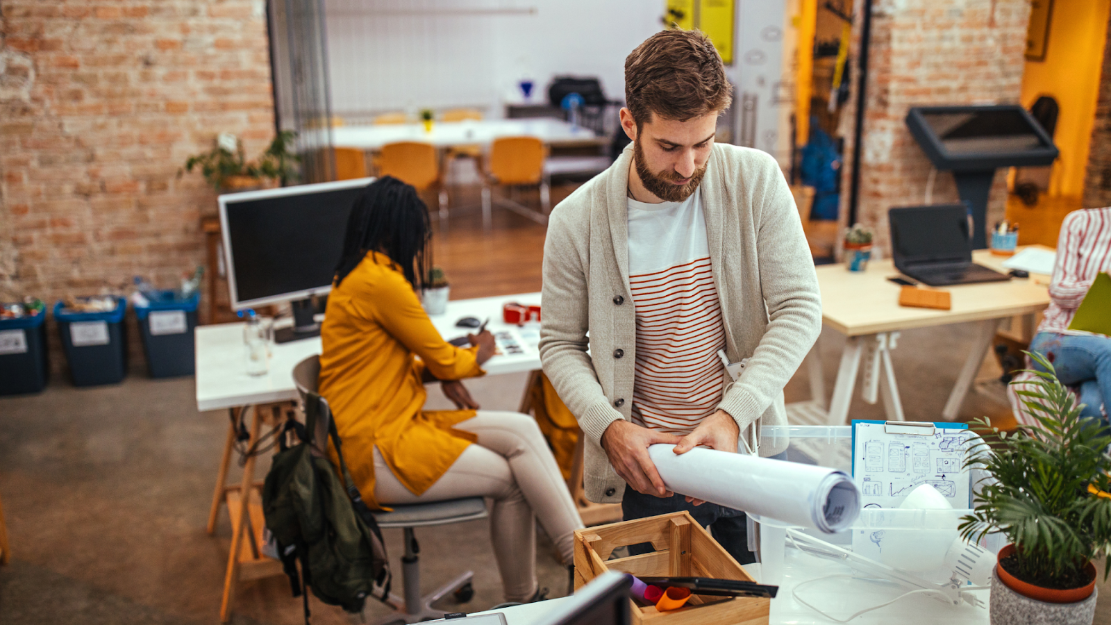 Amidst tech layoffs and a decline in remote work opportunities, an employee packs his belongings at work, uncertain of what his work future looks like