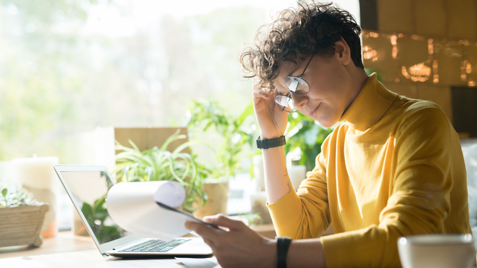 A remote employee in a yellow turtle neck feels insecure about the future of the job market.