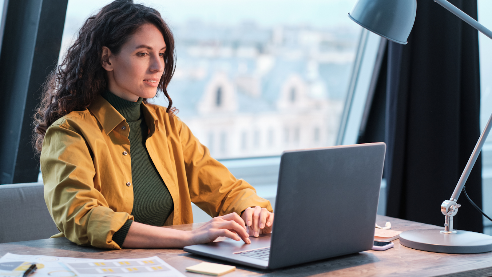 A focused business woman developing a temporary hiring strategy in a co-working space.