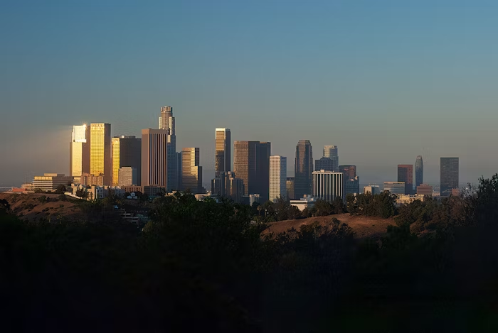 A panoramic view of downtown Los Angeles with office buildings at golden hour, symbolizing business growth and leadership opportunity.